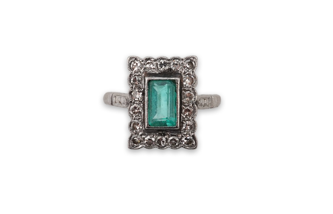 An emerald and diamond cluster ring, first half 20th century